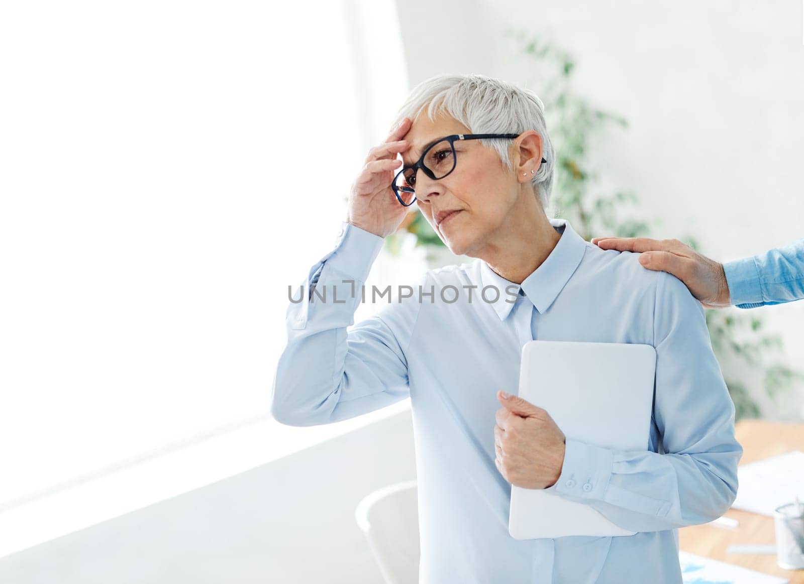 portrait of a senior business womanwith problems stressed in the office