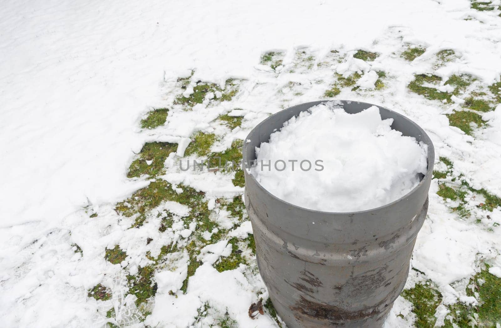 collection of snow in a tank to obtain melted water environmental issues protection day, earth saving natural resources, ecological footprint reduction, High quality photo