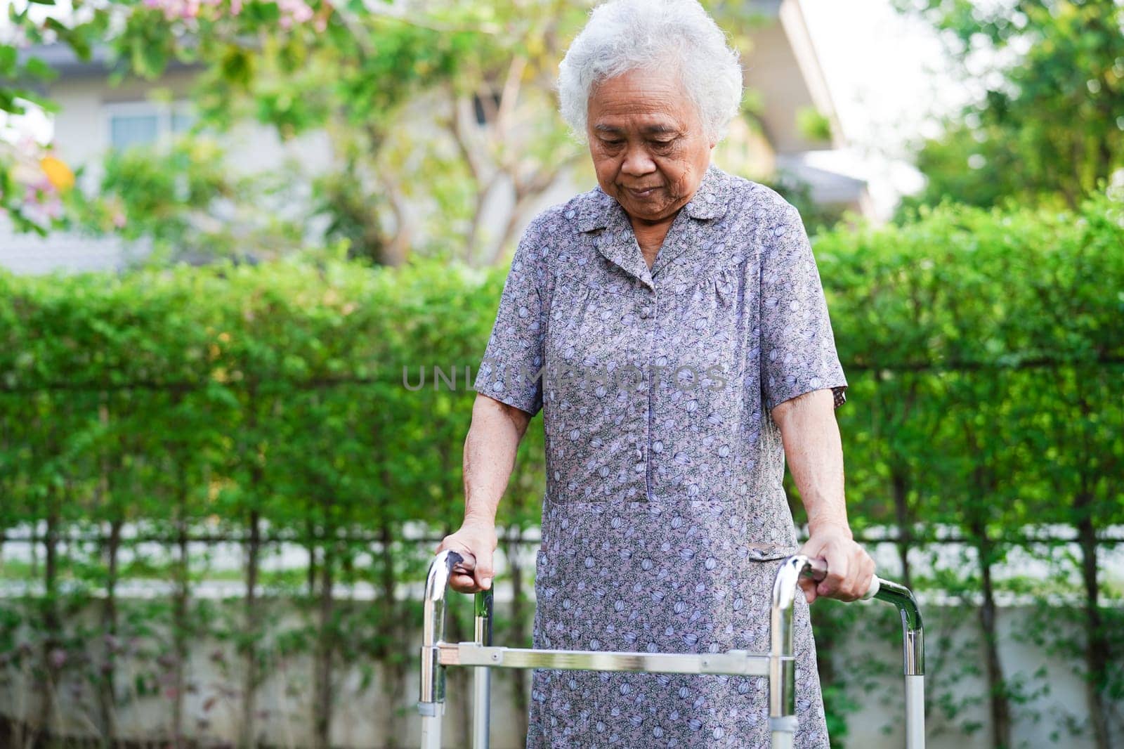 Asian elderly woman disability patient exercise on wheelchair with doctor in park, medical concept. by sweettomato