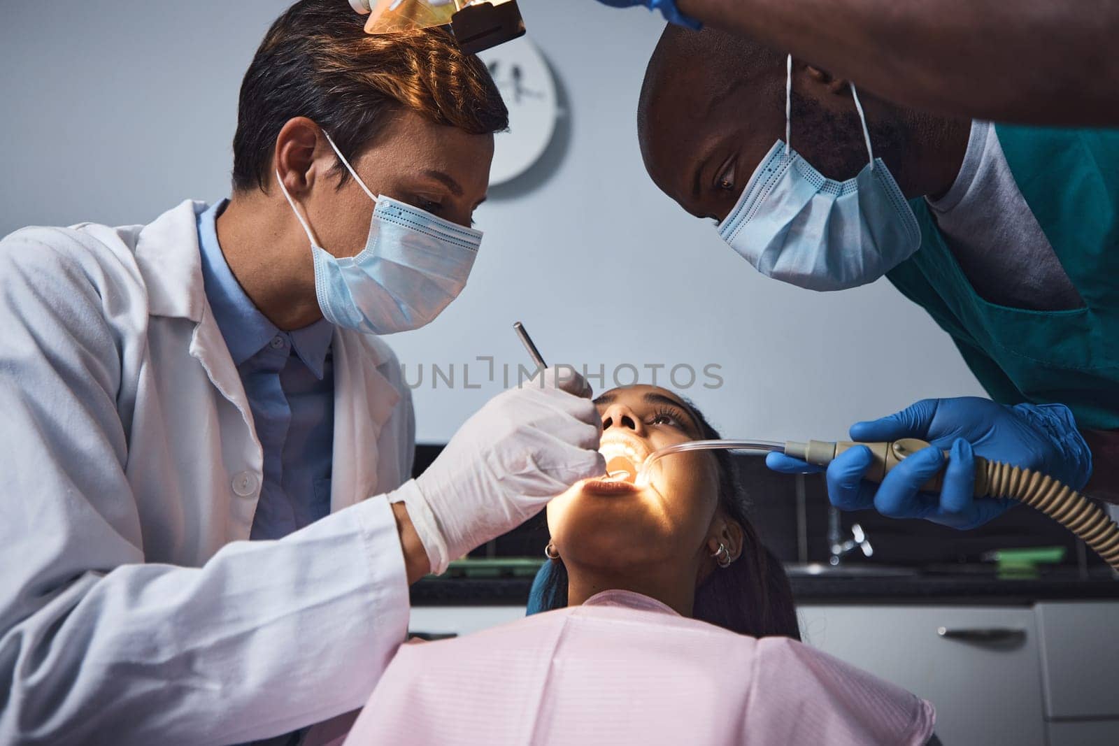 Their gentle care is the cure for any dental anxiety. a young woman having dental work done on her teeth. by YuriArcurs