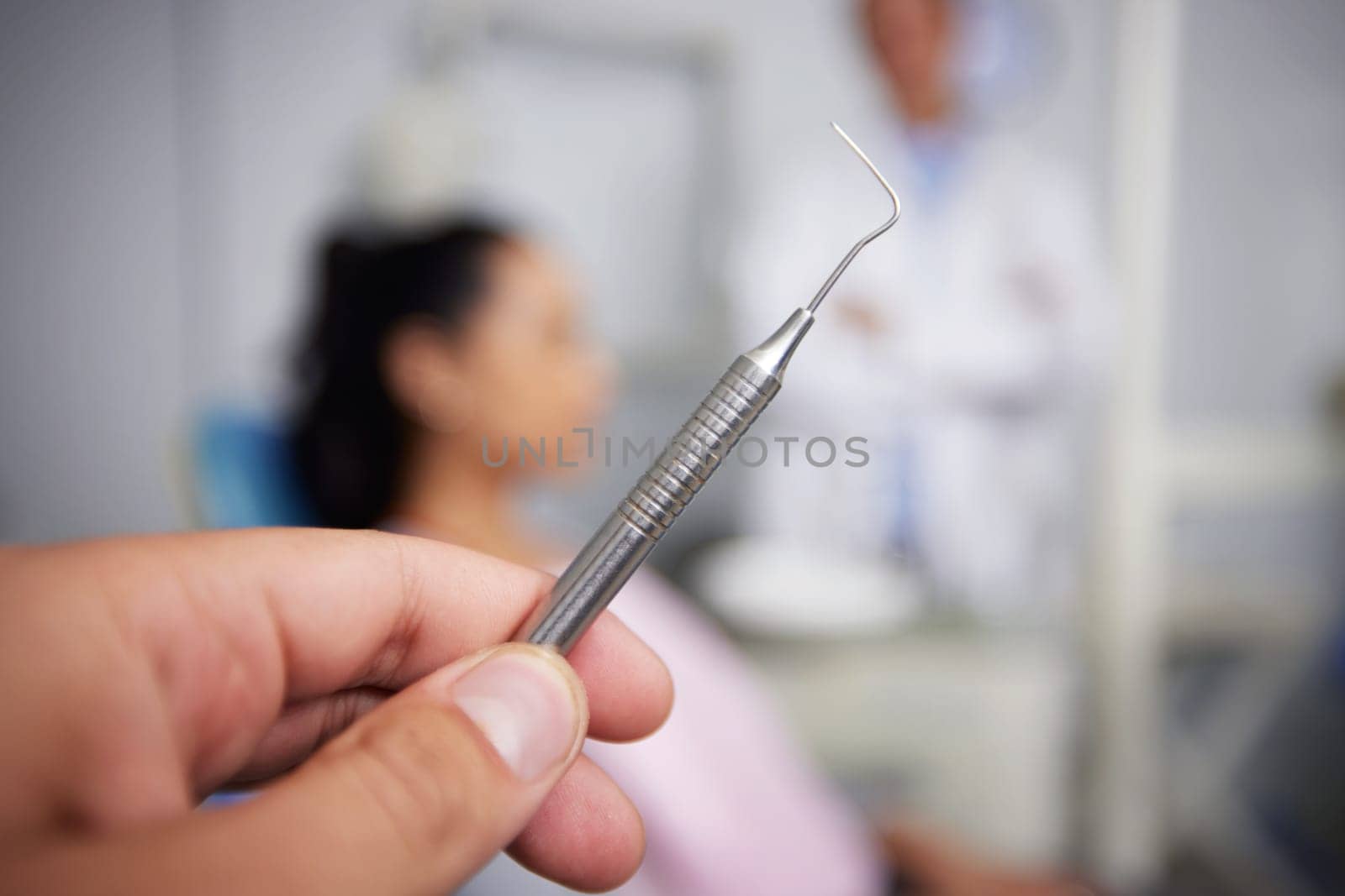 The moment of tooth. an unrecognisable dentist holding dental tools in an office. by YuriArcurs