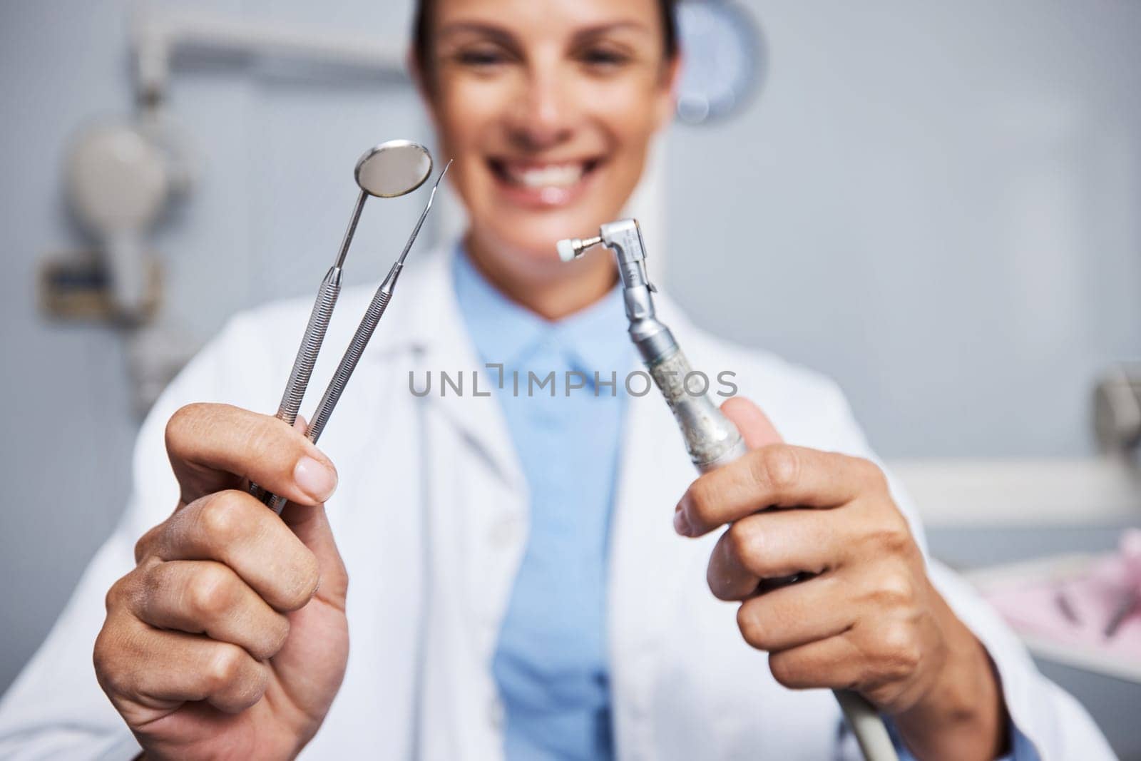 These clean like a dream. Portrait of a young woman holding teeth cleaning tools in her dentists office. by YuriArcurs