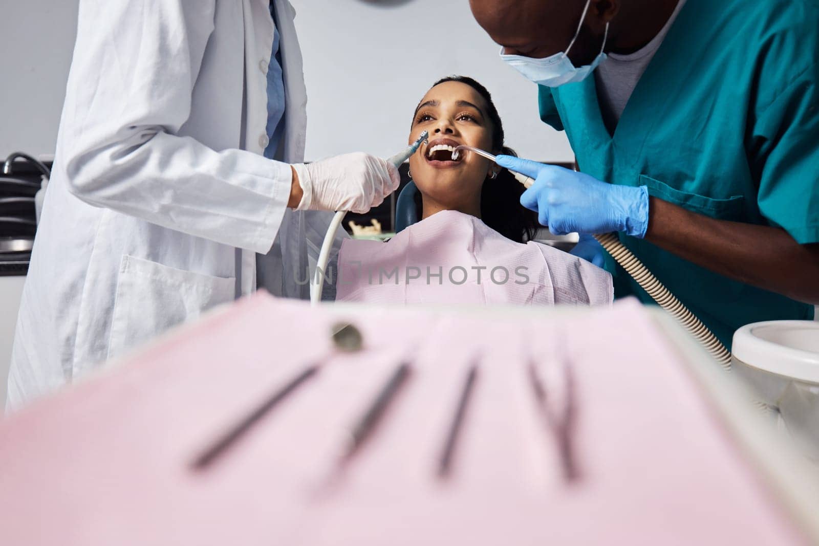 A positively pain free experience. a young woman having dental work done on her teeth. by YuriArcurs