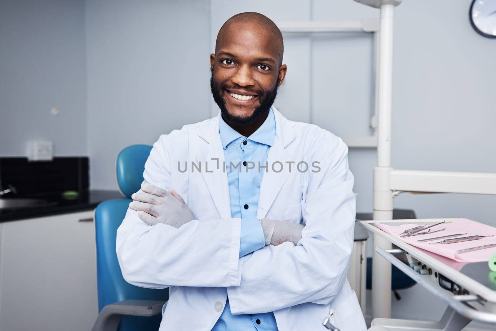 Have a dental health concern Come see me. Portrait of a confident young man working in a dentists office