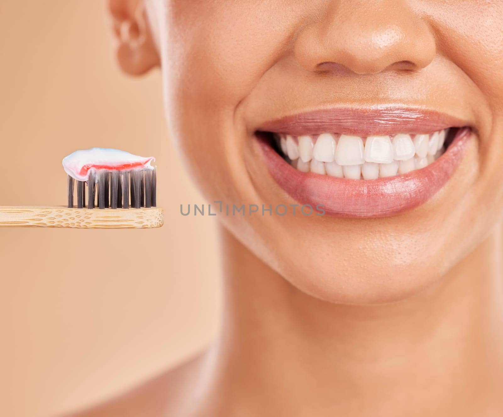 Toothpaste, bamboo toothbrush and smile of woman in studio isolated on a brown background. Sustainable, eco friendly and face of happy female with wood brush for brushing teeth and dental health. by YuriArcurs