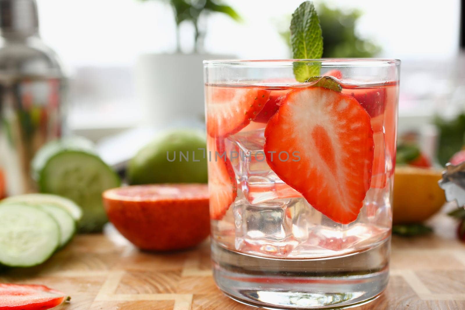 Strawberry punch with mint and ice in glass by kuprevich