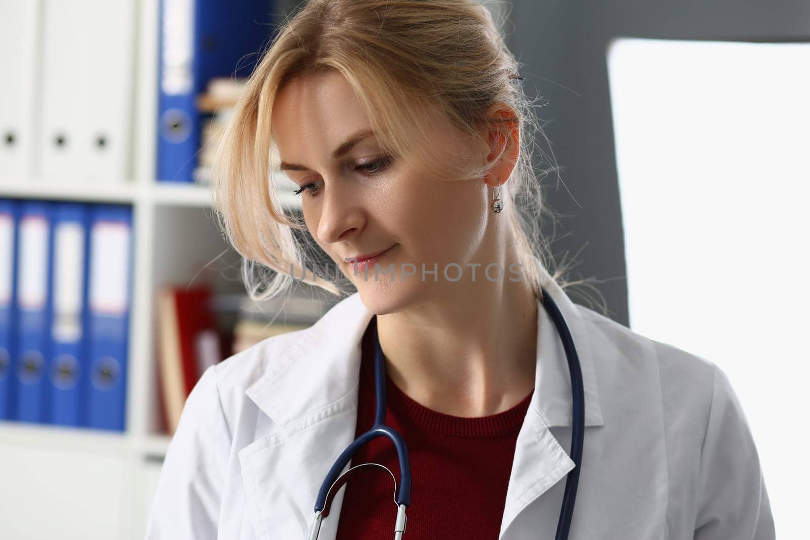 Portrait of sad female doctor in clinic. Doctor surgeon therapist looks tired and bored from depressive problems in clinic