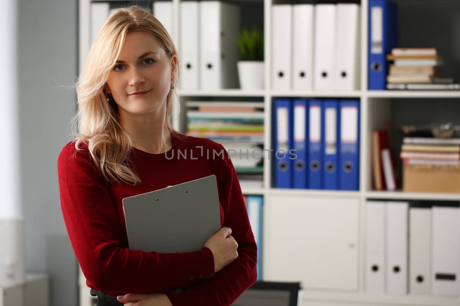 Woman secretary manager is holding documents in office. Businesswoman and assistant consultant concept