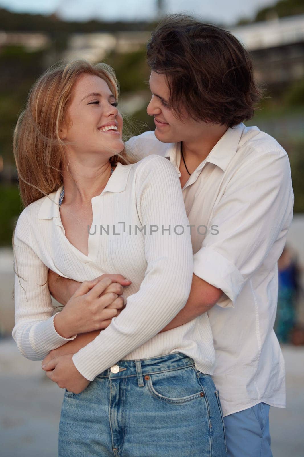 Couple hug on beach, happy and travel with love and commitment in relationship, adventure and romance. Trust, partnership and care with young people outdoor, tropical holiday and happiness on date.