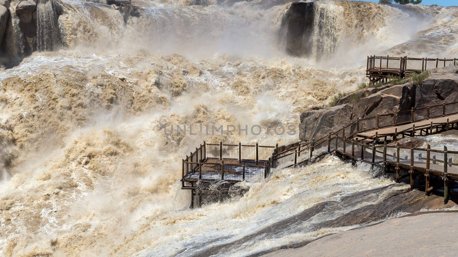 A flooded viewpoint at the main Augrabies waterfall in the Orange River
