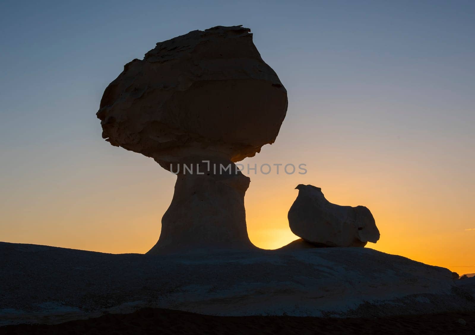 Landscape scenic view of desolate barren western desert in Panoramic barren landscape in Egypt Western White desert with silhouette of chicken and mushroom geological rock formations