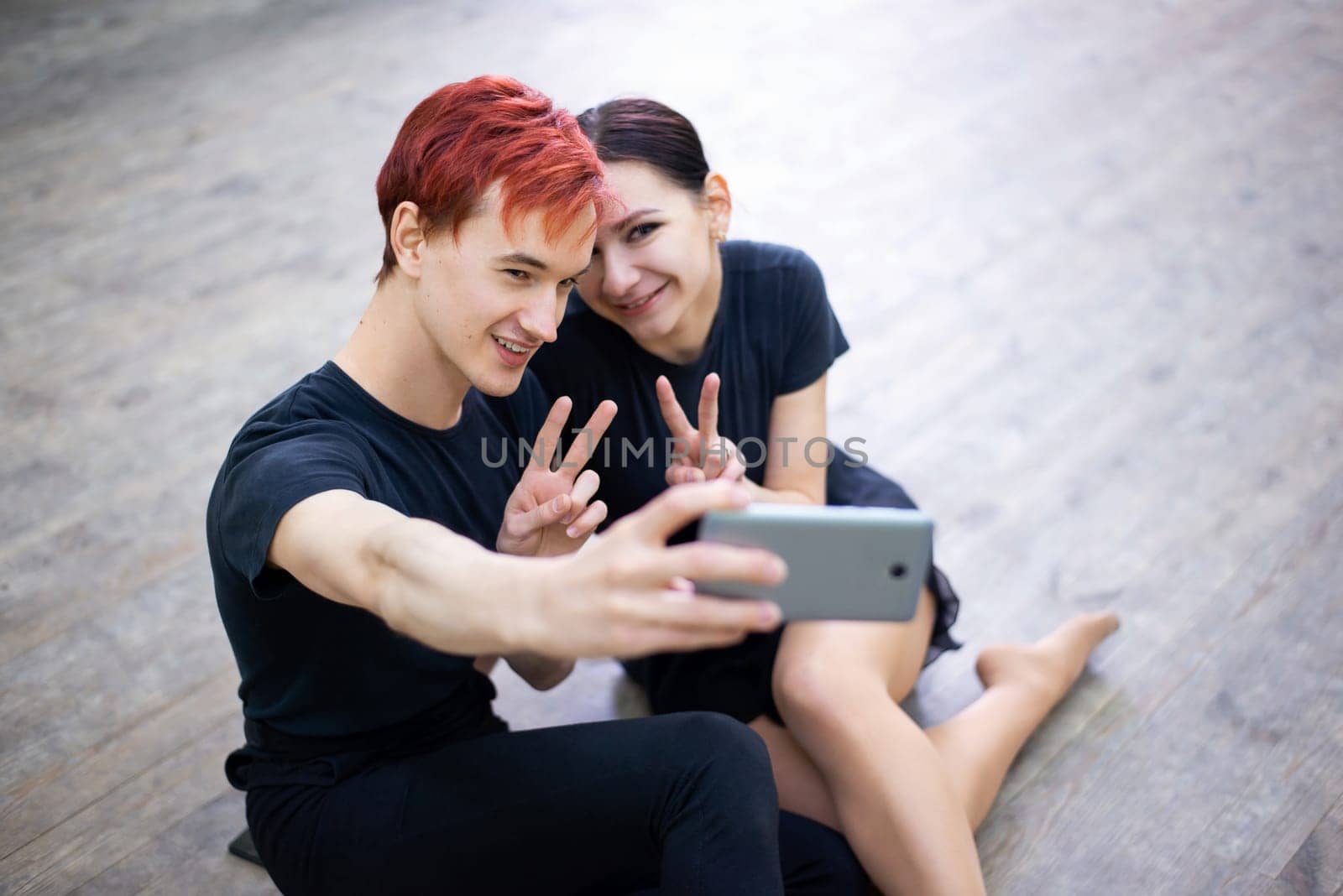 Male and female dancers making selfie after lesson of dancing by VitaliiPetrushenko
