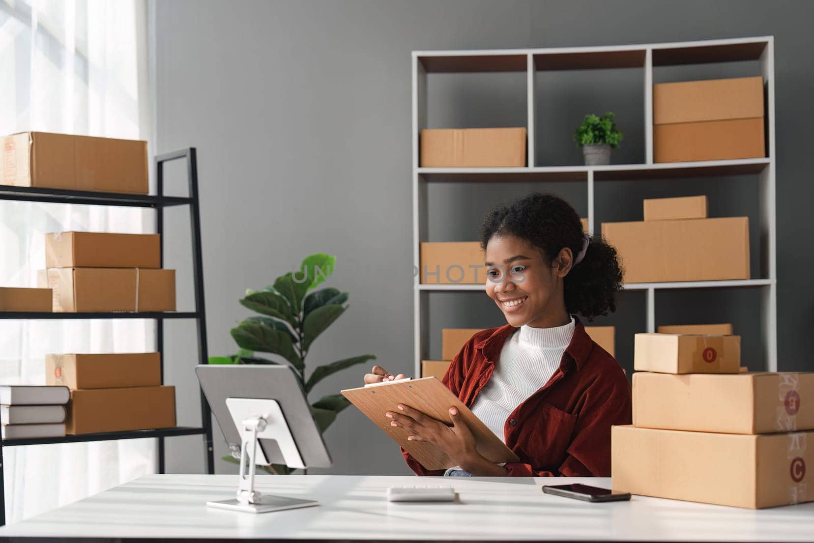 Beautiful African Americans woman live streaming at her shop. Business online influencer on social media concept. Online Selling. Online Shopping.