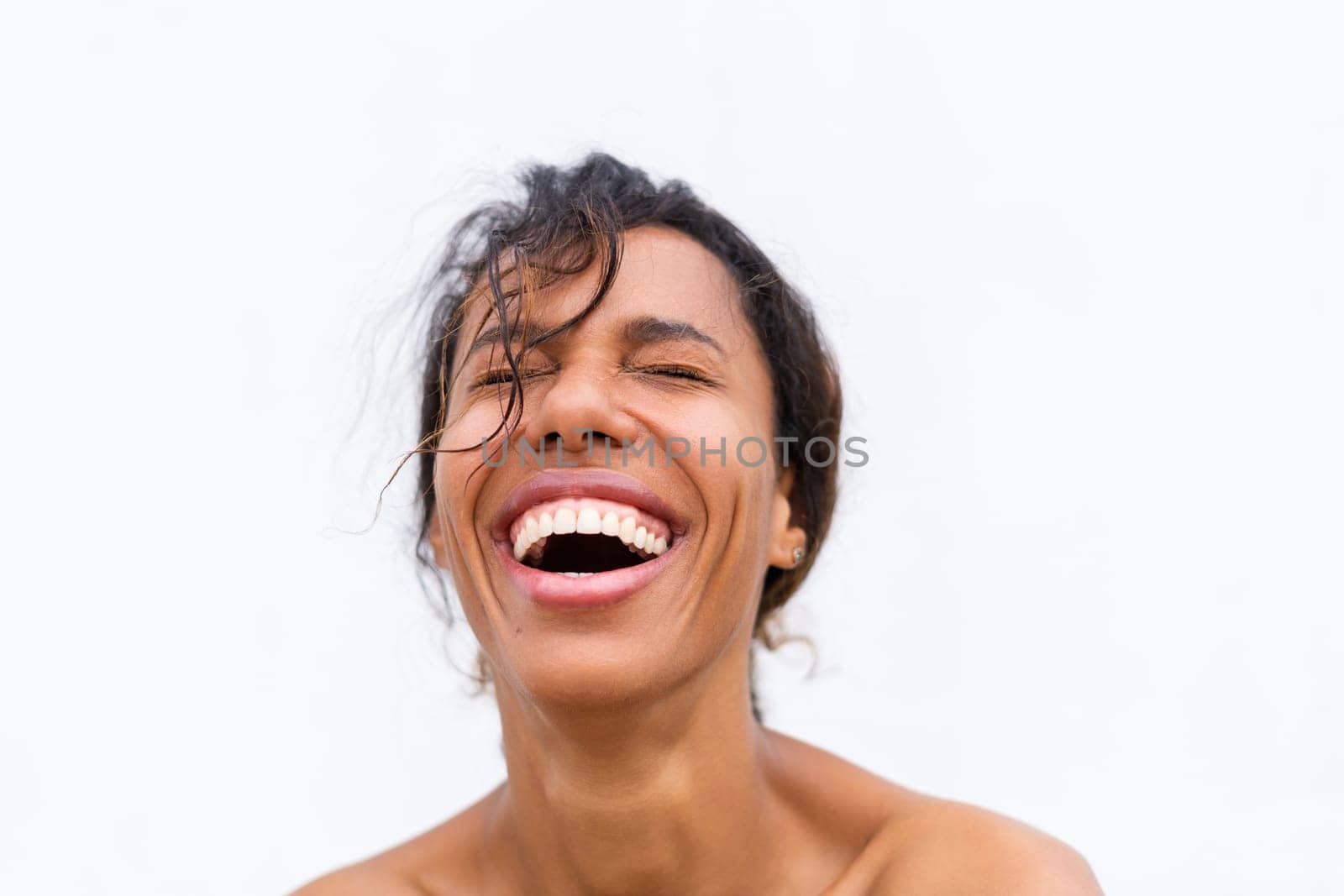 Beauty portrait of young topless african american woman with bare shoulders on white background with perfect skin and natural makeup positive laughing by kroshka_nastya
