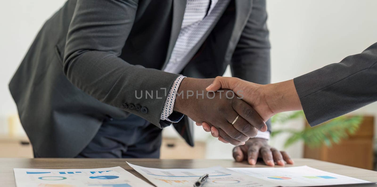 Businessmen making handshake with partner, greeting, dealing, merger and acquisition, business cooperation concept, for business, finance and investment background, teamwork and successful business by wichayada
