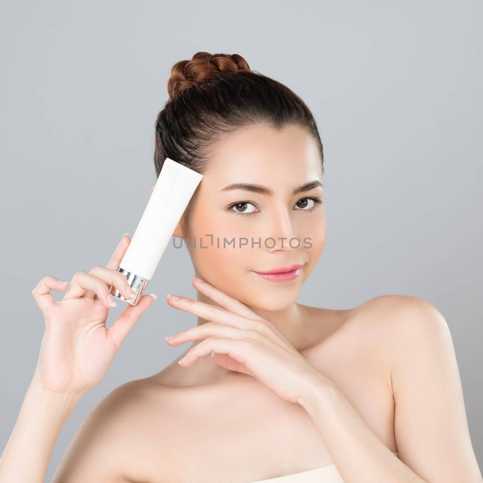 Glamorous perfect skin woman holding mockup moisturizer tube. by biancoblue