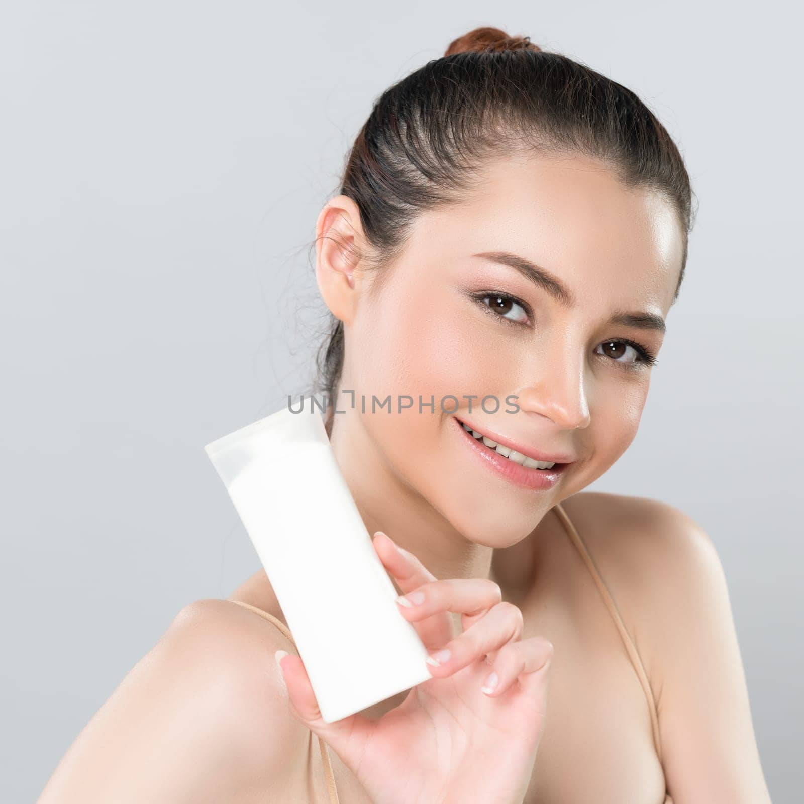 Glamorous perfect skin woman holding mockup moisturizer tube. by biancoblue