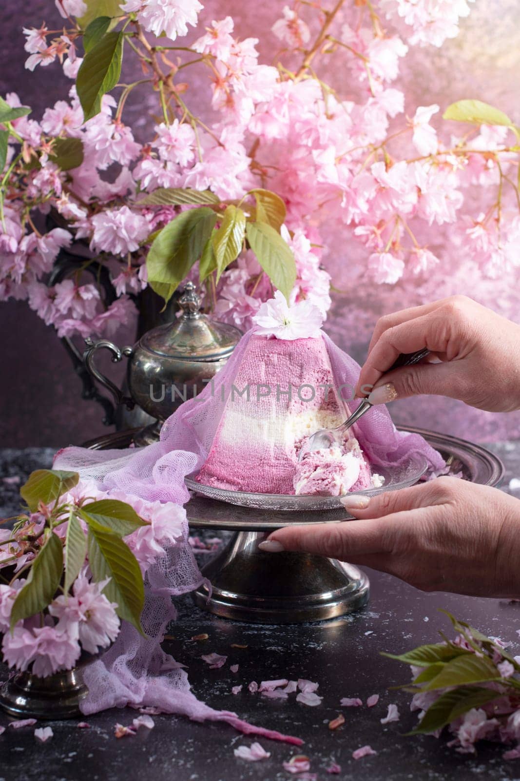 Traditional Easter Orthodox curd cake with blueberry. Traditional Easter curd cake with sakura flowers, woman decorating food, High quality photo