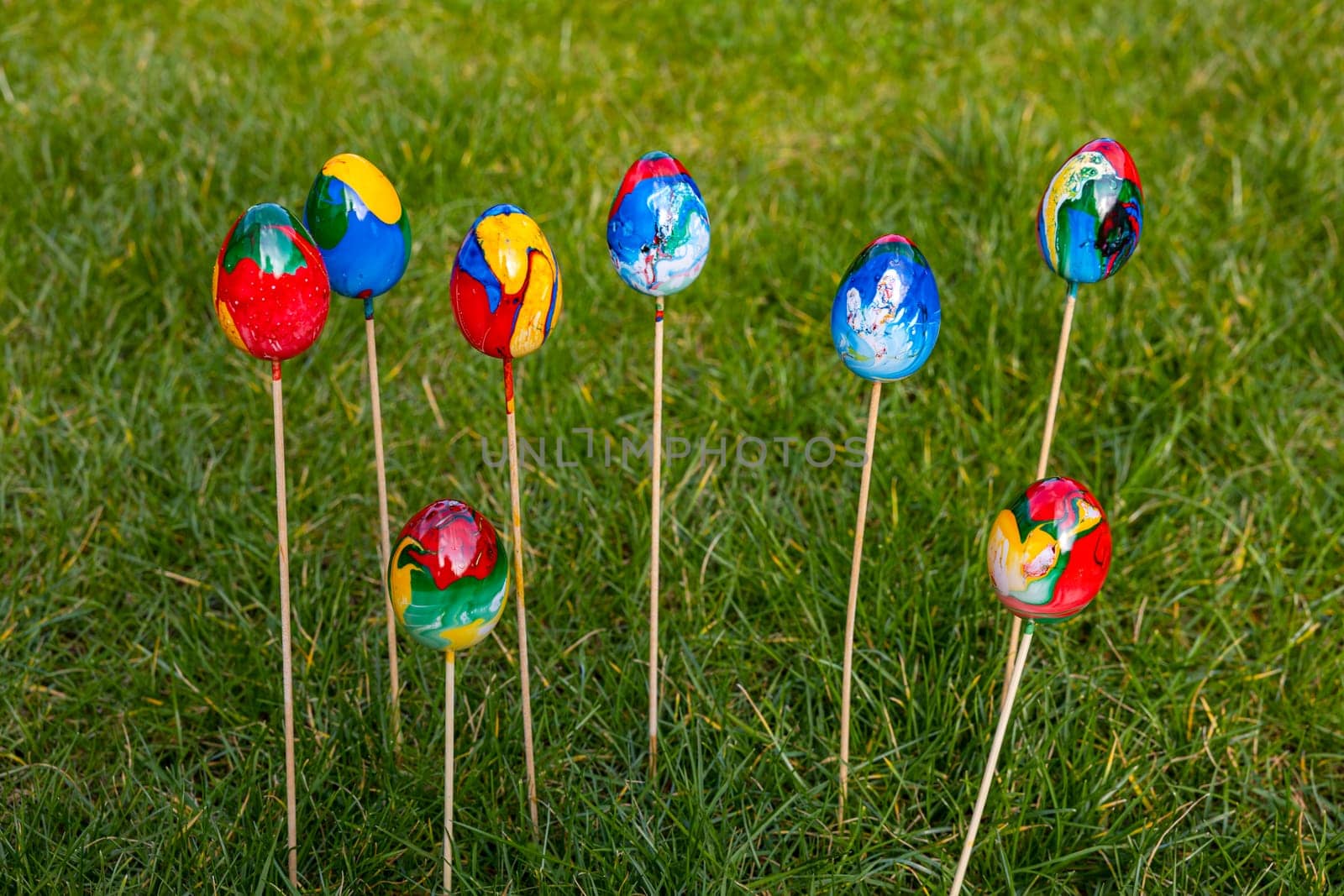 Marbled colored colorful easter eggs isolated with selective focus in the garden