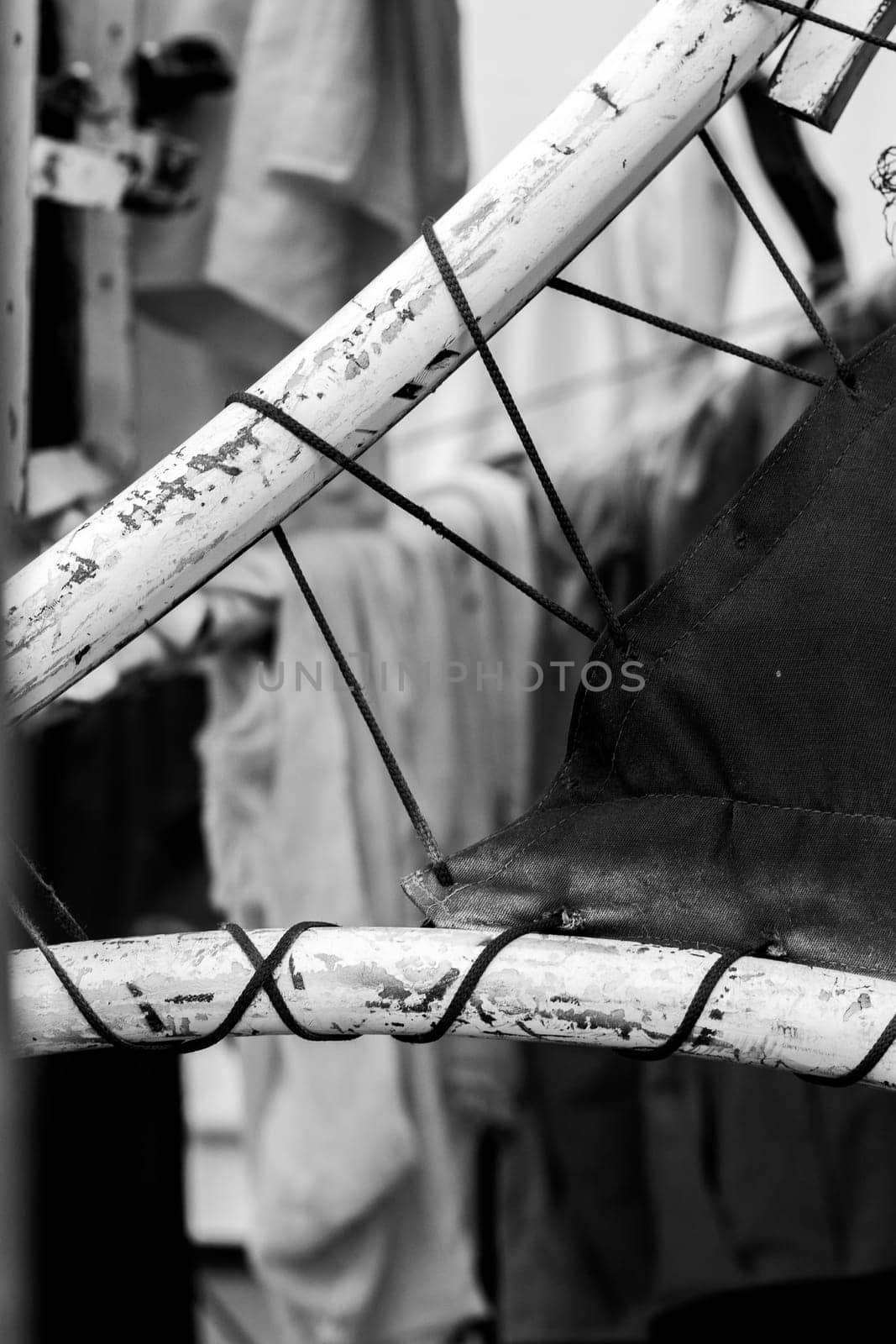 Abstract background of a thread stretched between curved tubes. Black and white photo.