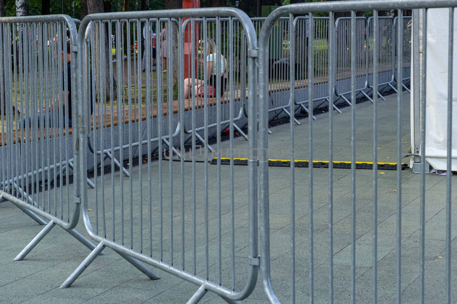 Metal fences at mass events protect people. Prohibition of passage.