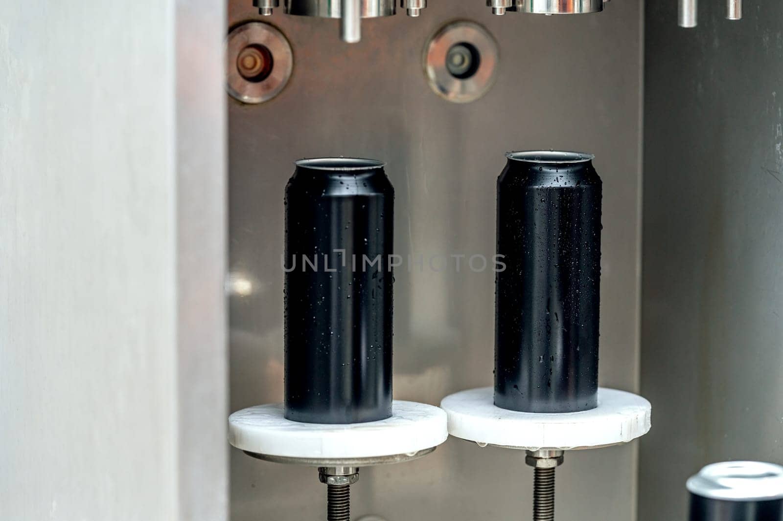 automatic filling and sealing of drink cans in the factory.
