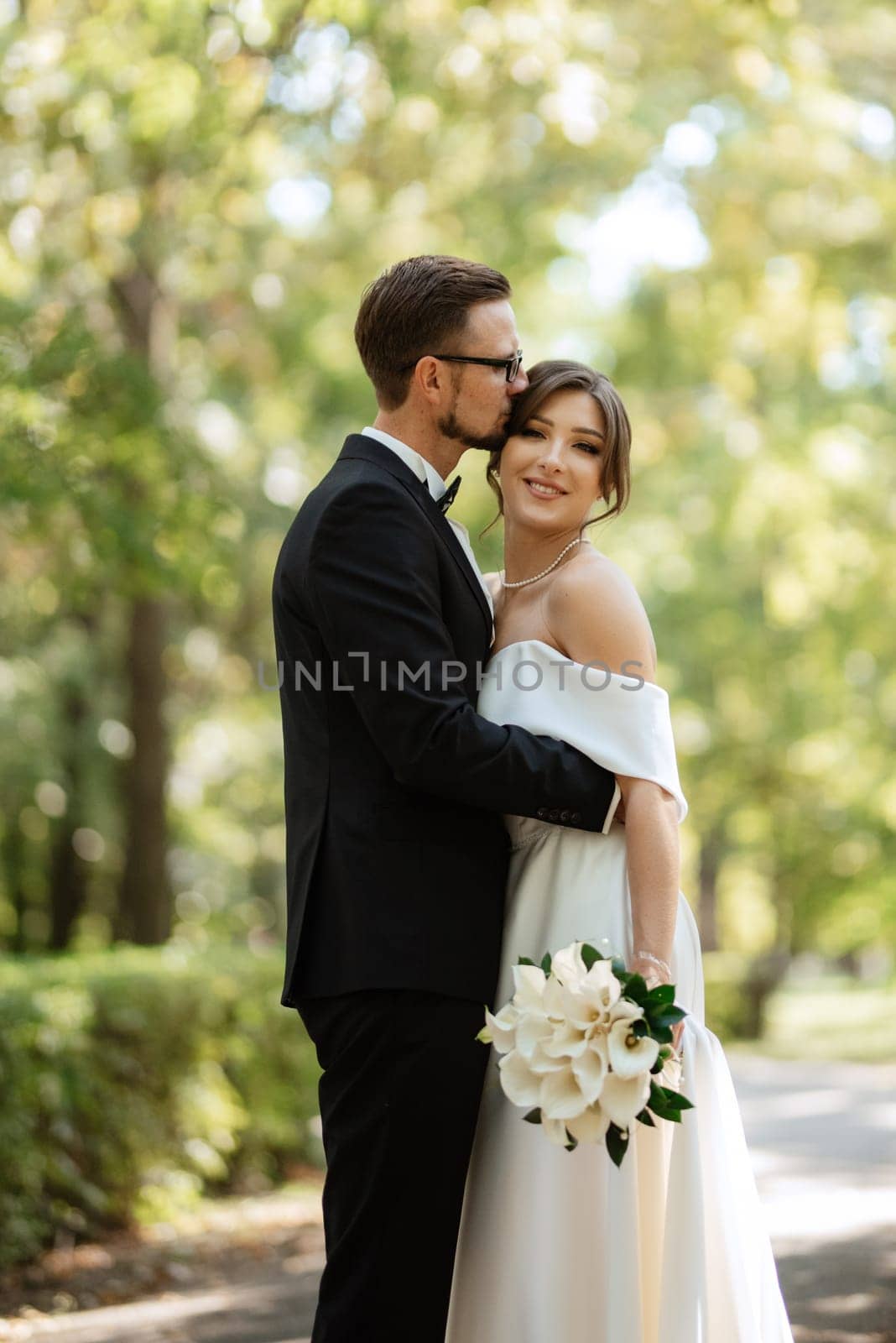 the first meeting of the bride and groom in wedding outfits in the park