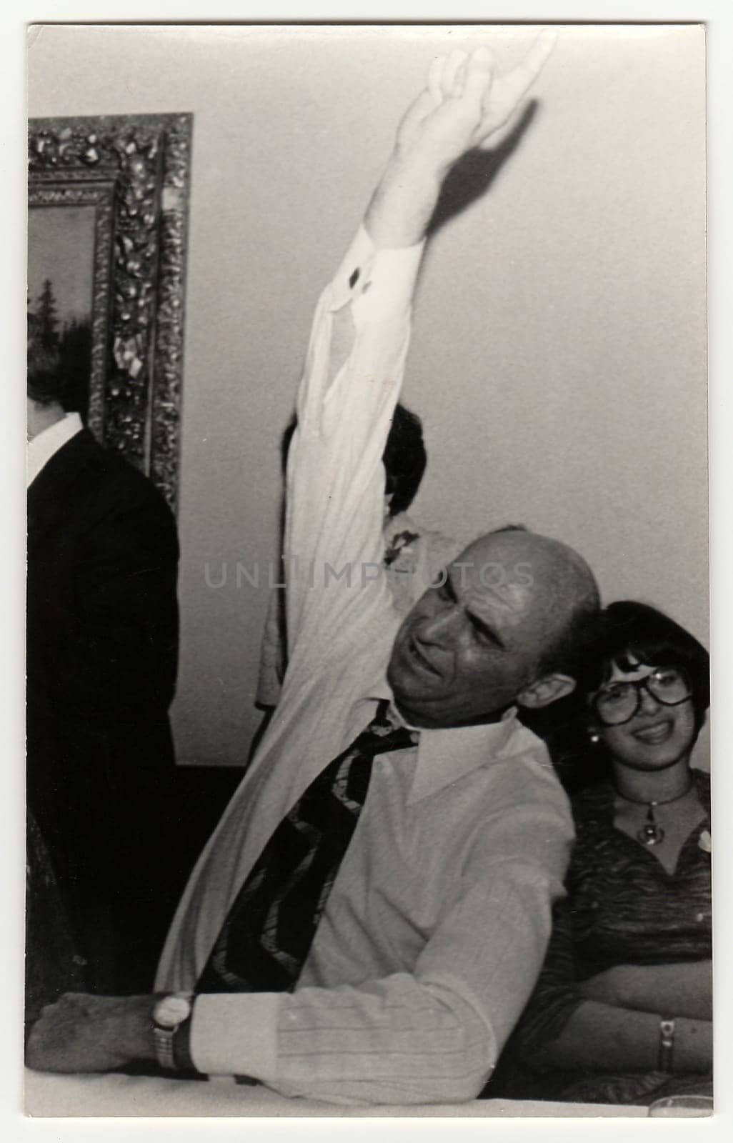 Vintage photo shows drunk man during a party. by roman_nerud