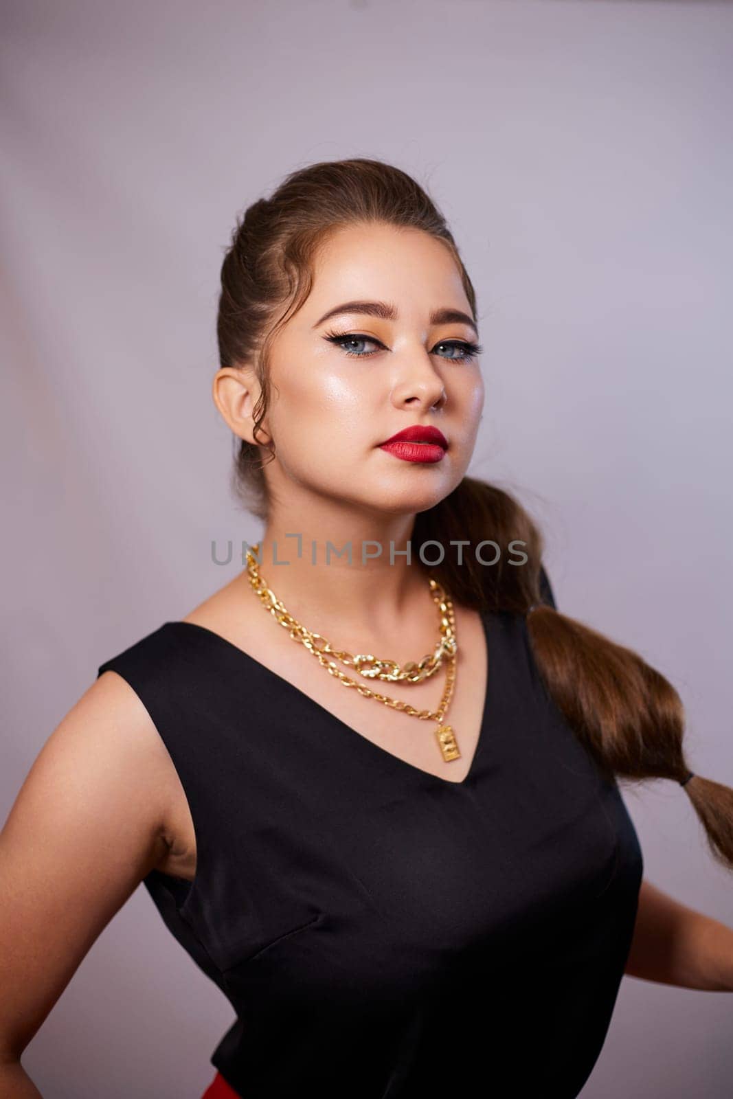 portrait shot of a young Ukrainian woman on the background, after make-up and hairstyle, for clothing advertising.