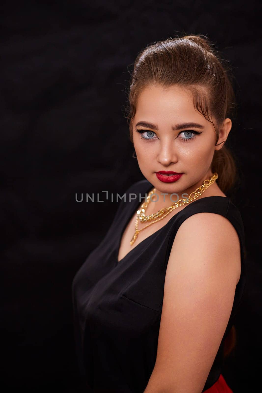 portrait shot of a young Ukrainian woman on the background, after make-up and hairstyle, for clothing advertising.