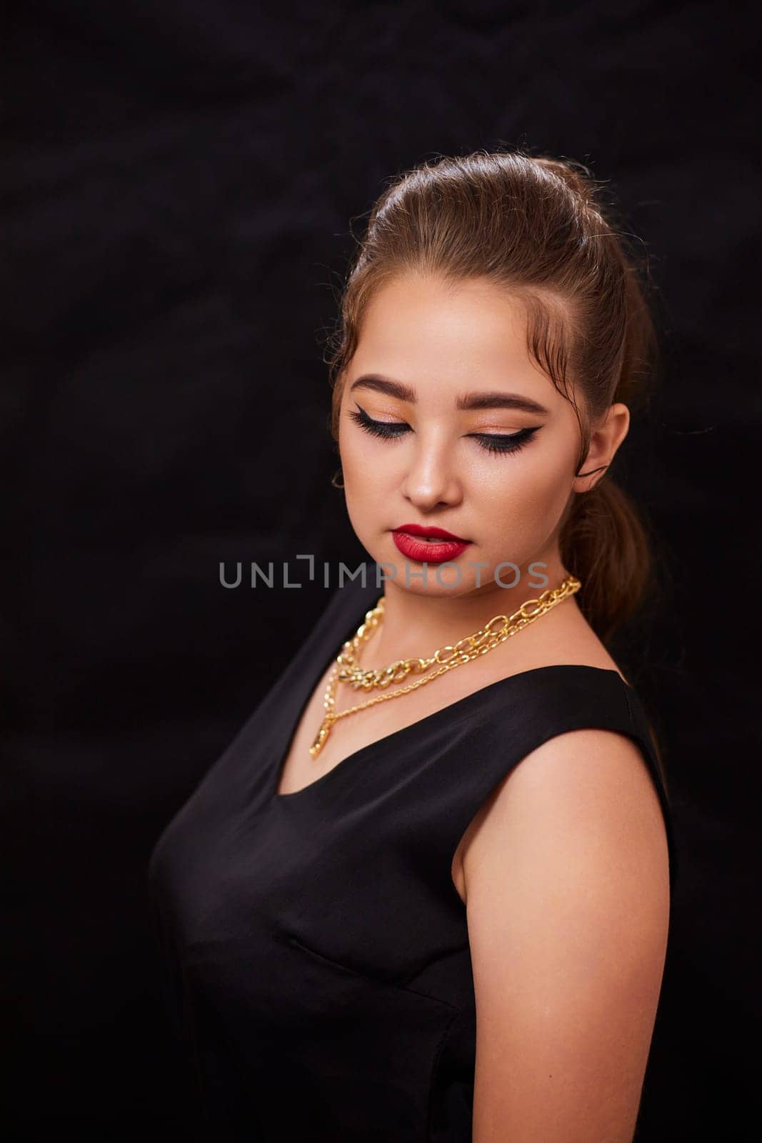 portrait shot of a young Ukrainian woman on the background, after make-up and hairstyle, for clothing advertising.