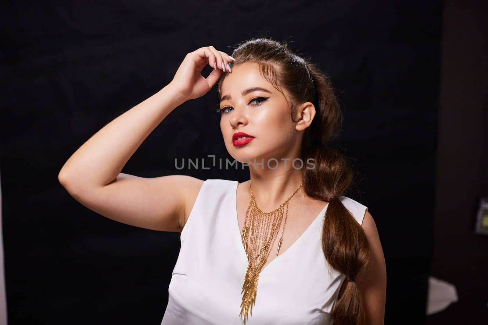 portrait shot of a young Ukrainian woman on the background, after make-up and hairstyle, for clothing advertising.