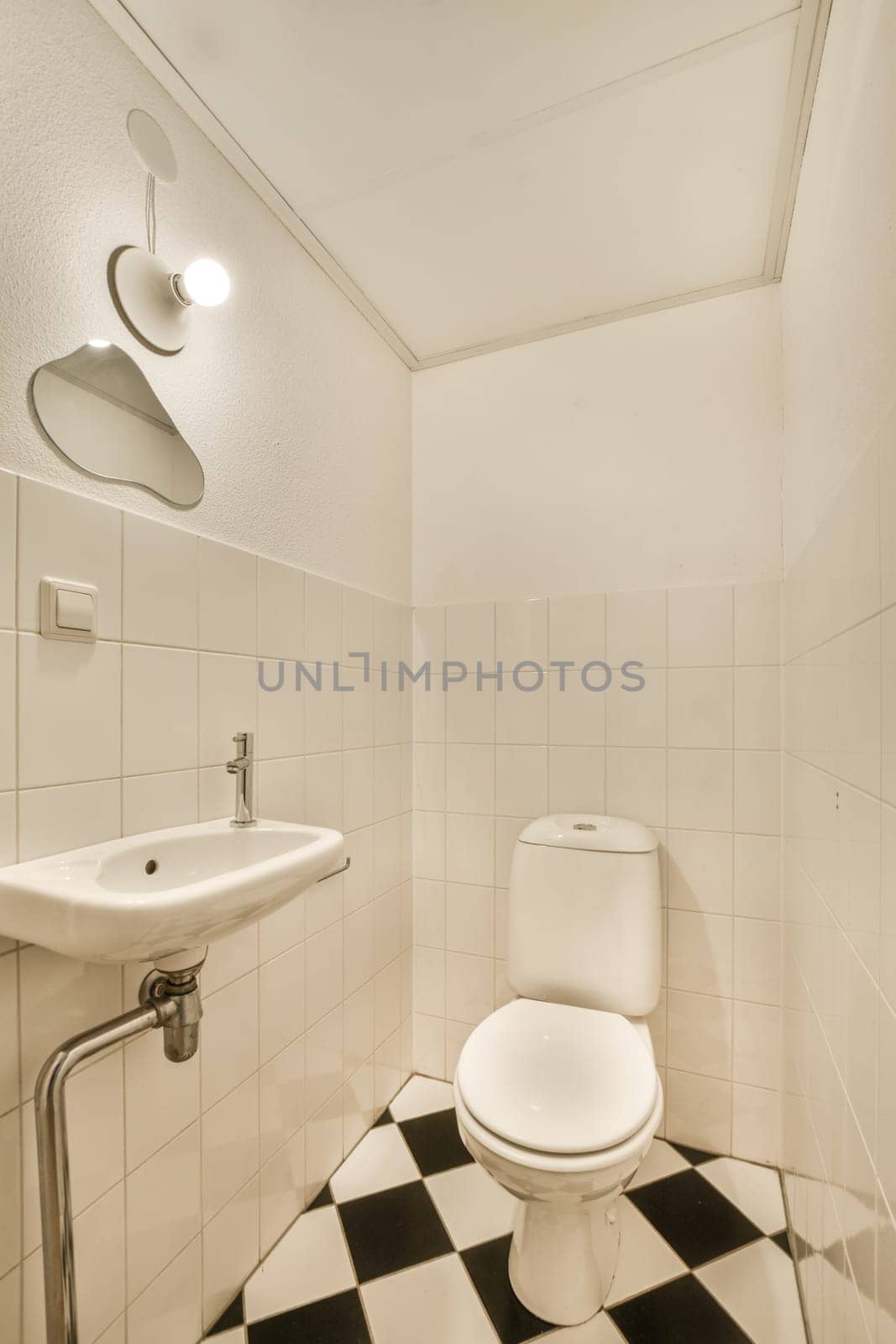 a bathroom with black and white checkered flooring on the walls, toilet is in the center of the room