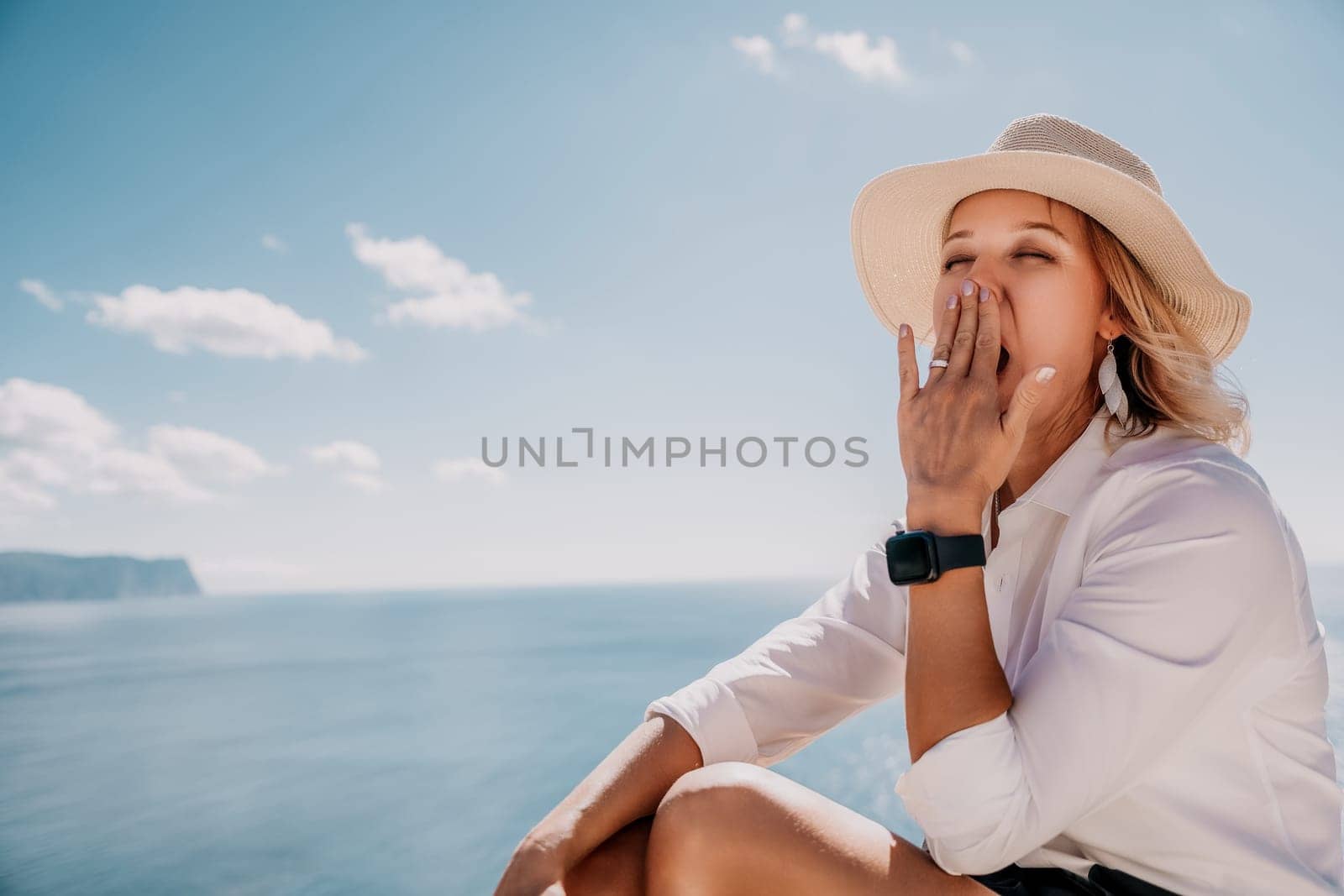 Happy girl doing yoga with laptop working at the beach. beautiful and calm business woman sitting with a laptop in a summer cafe in the lotus position meditating and relaxing. freelance girl remote work beach paradise