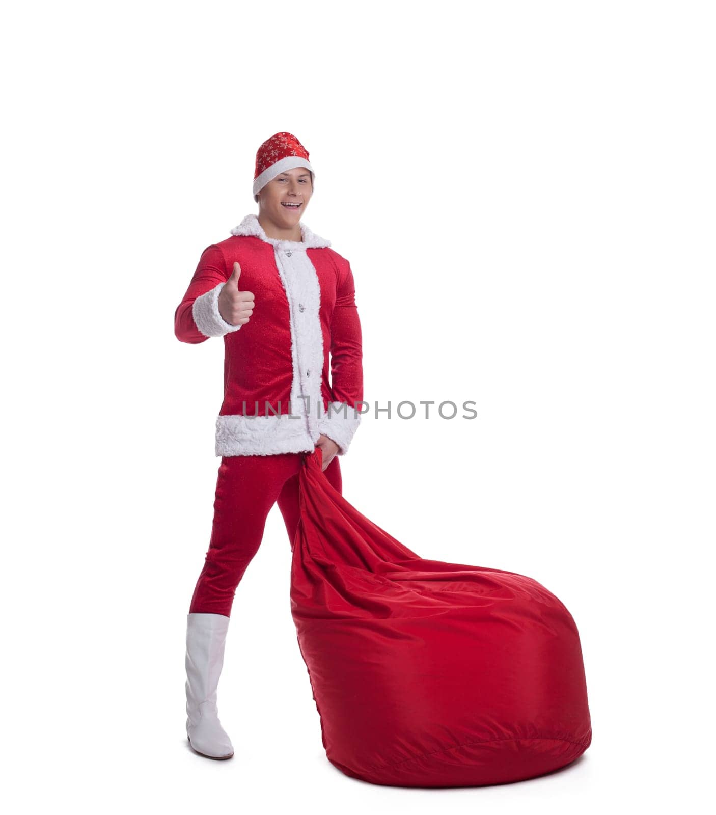 Happy young santa claus with huge red bag thumbs up isolated