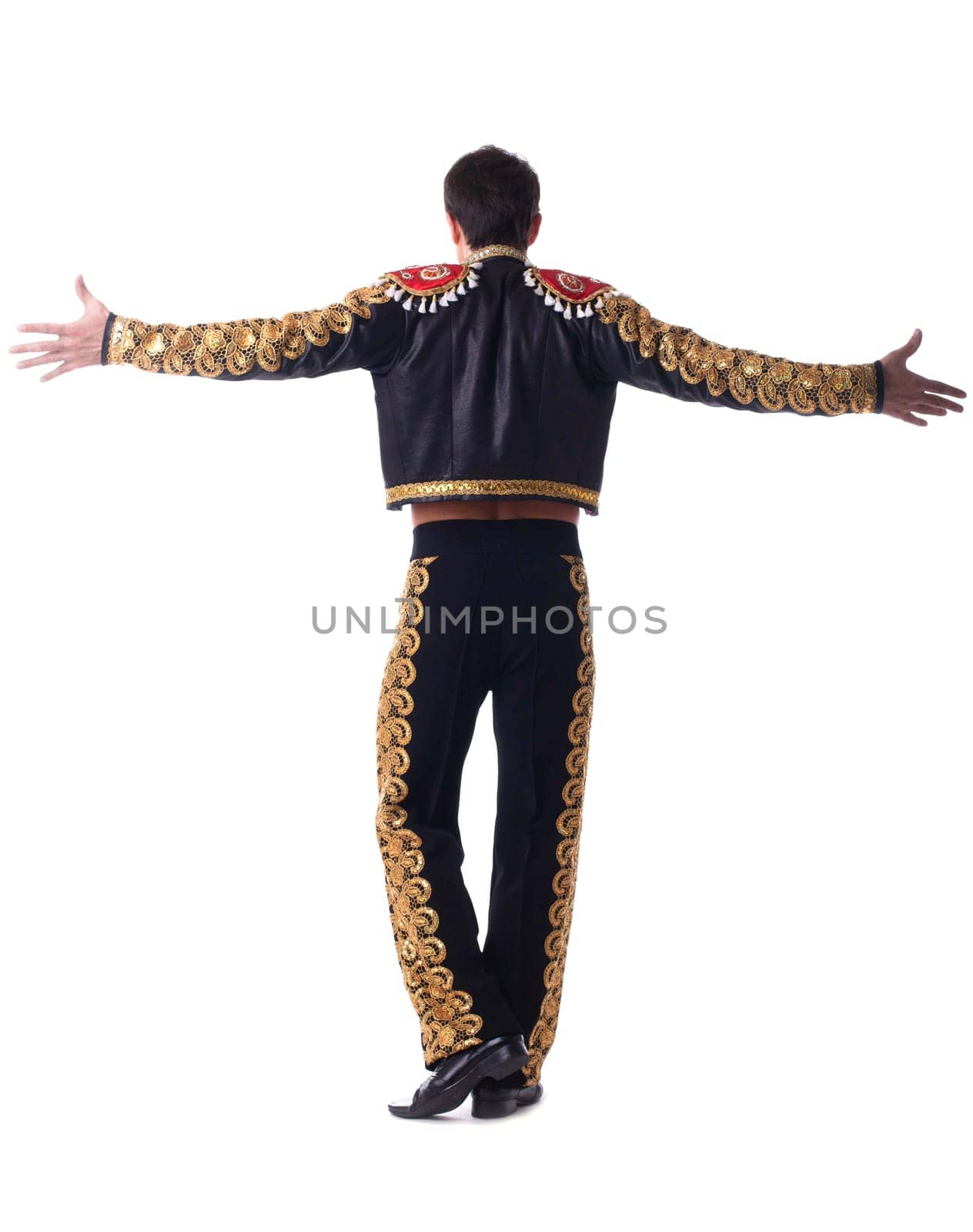 Full length portrait of toreador in black costume dansing. Isolated on white