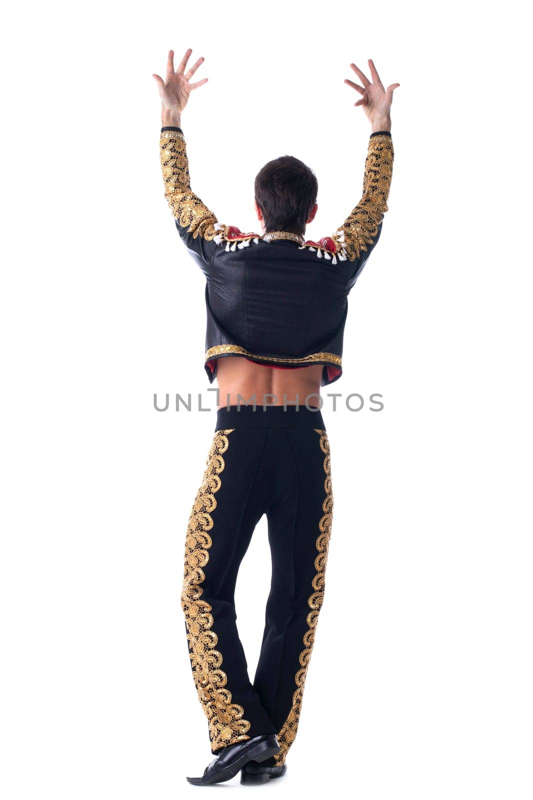 Full length portrait of young toreador in black and gold costume dansing. Isolated on white