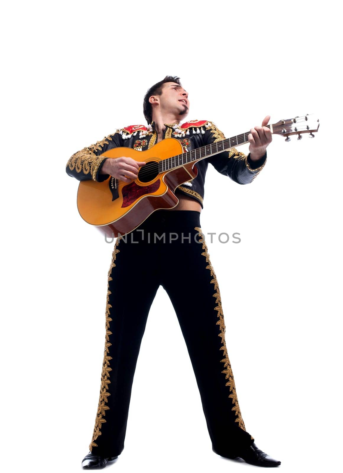 Full length portrait of toreador playing guitar. Isolated on white