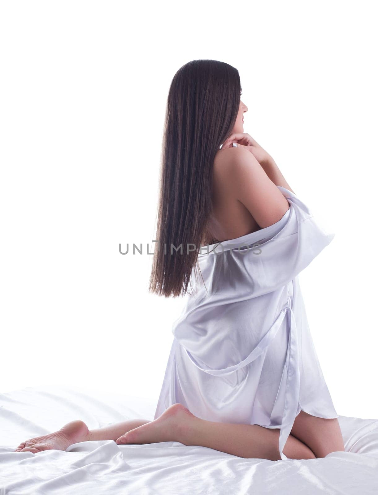 Beauty young woman posing in sexy silk on bed Isolated