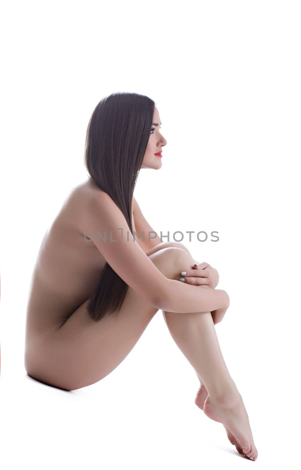 Beautiful woman with long hair posing naked isolated
