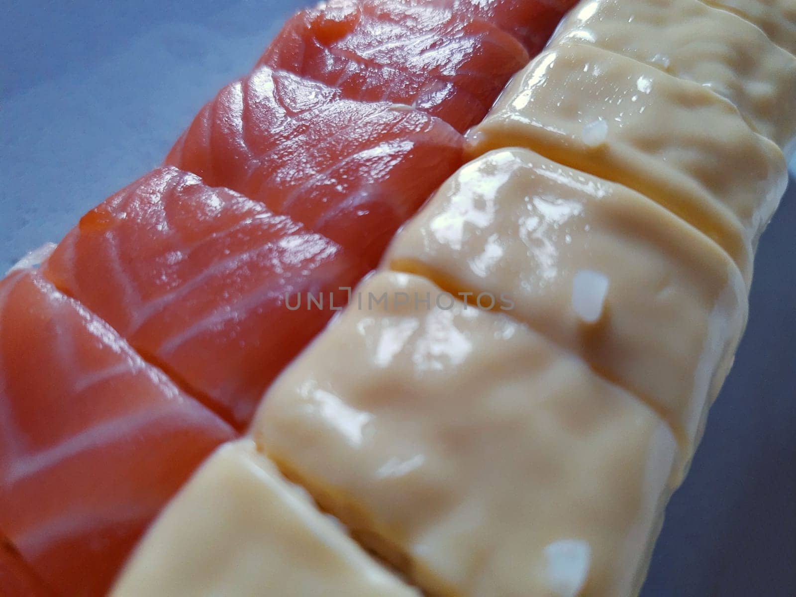 Appetizing sushi with fish and cheese close up.