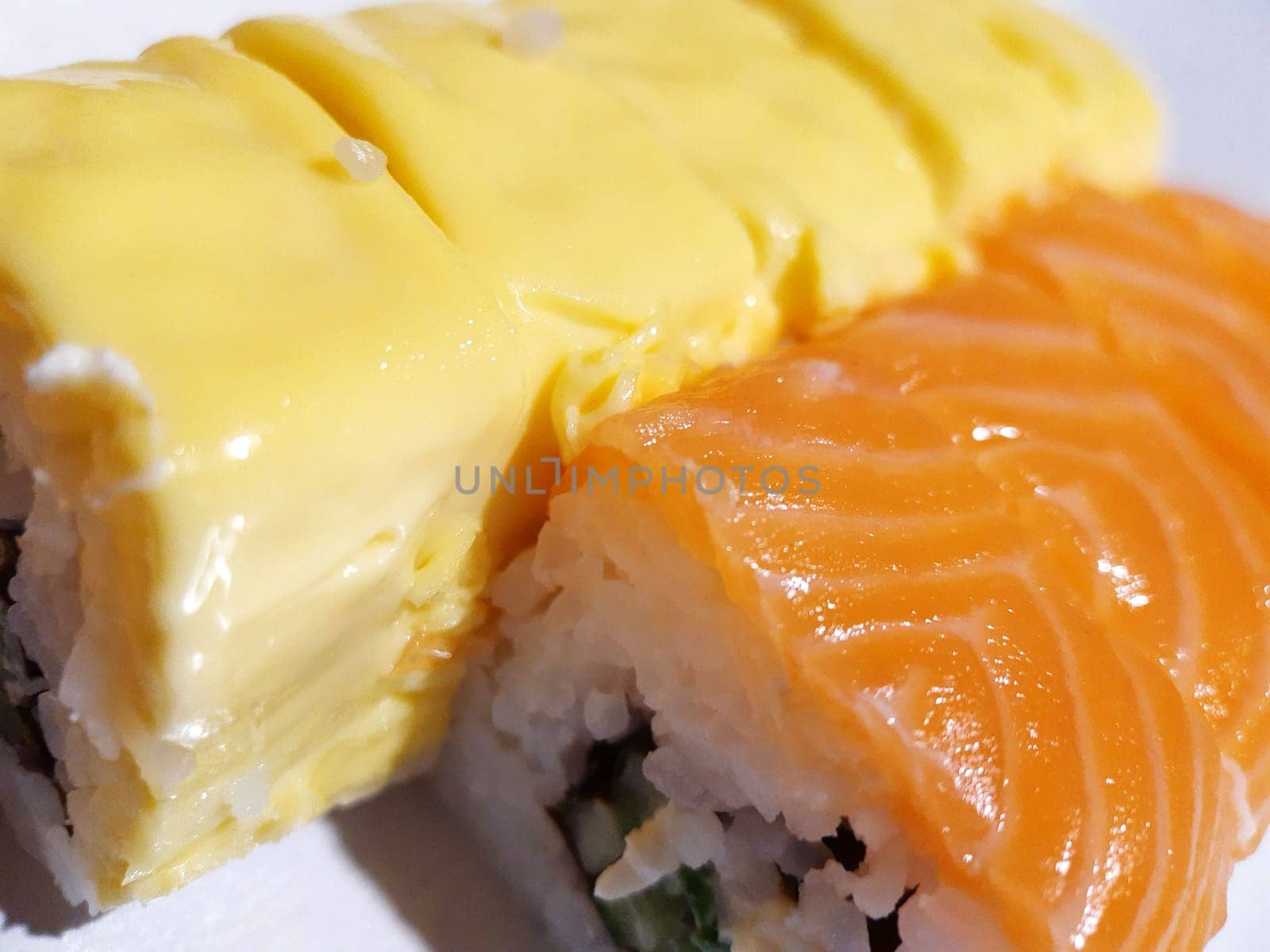 Appetizing sushi with fish and cheese close up.