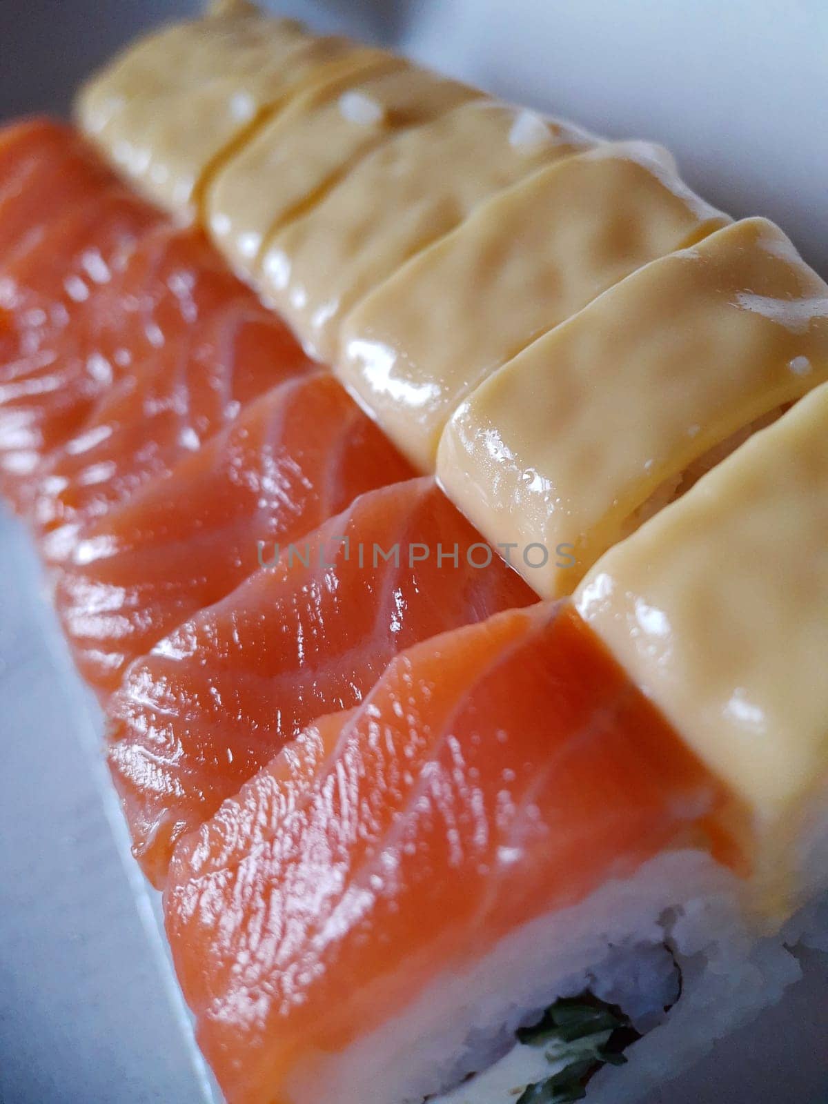 Appetizing sushi with fish and cheese close up.