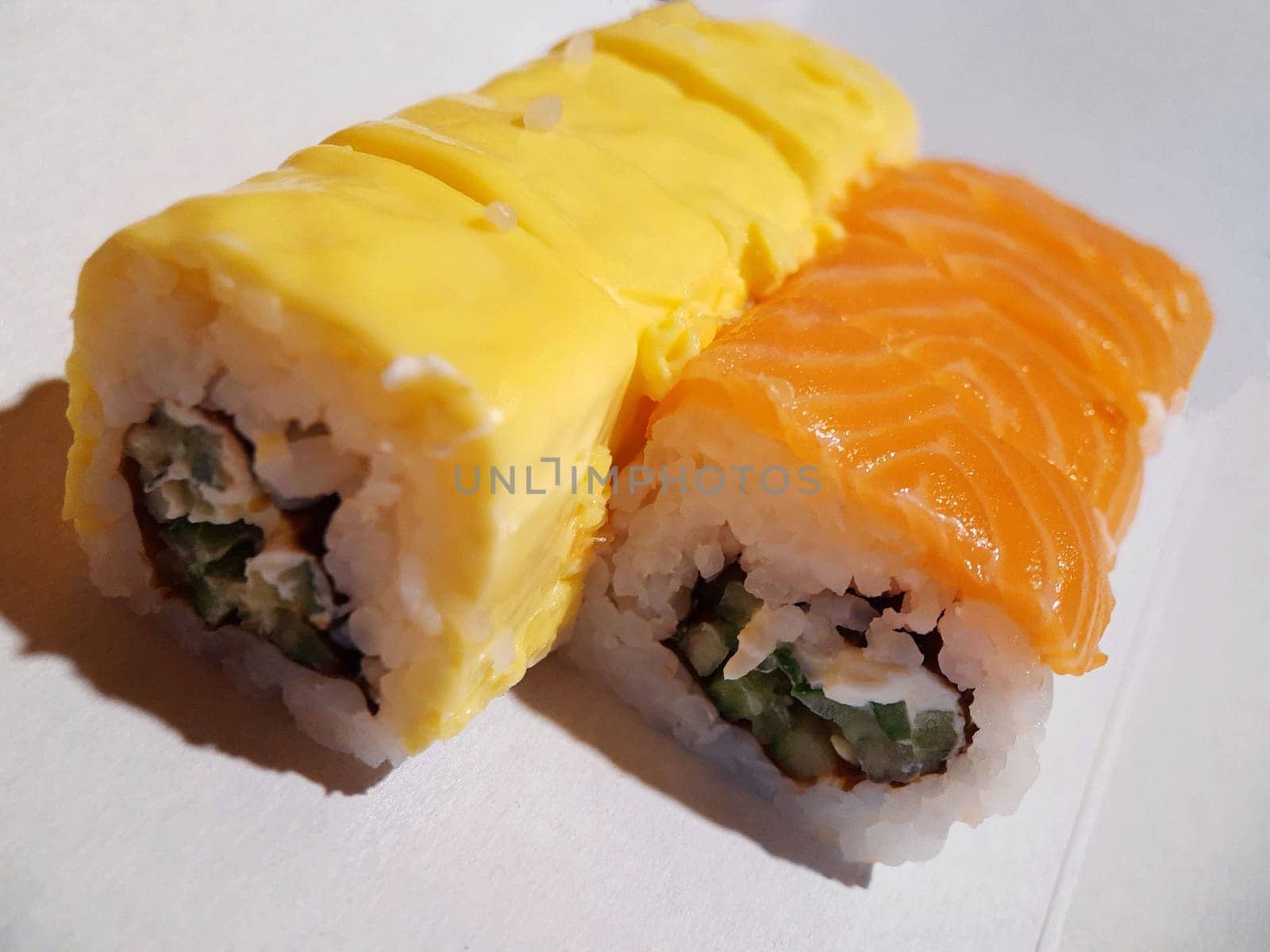 Appetizing sushi with fish and cheese close up.