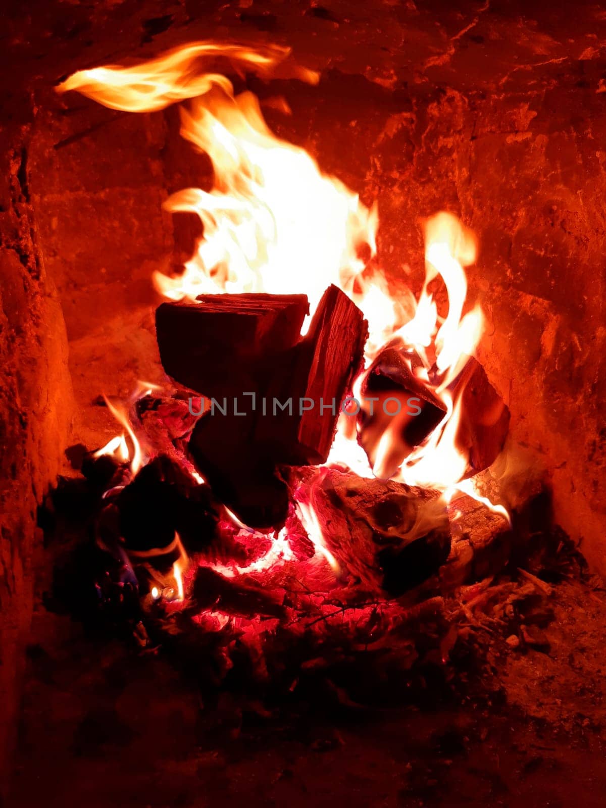 Night fire in the fireplace while relaxing in the country close-up.