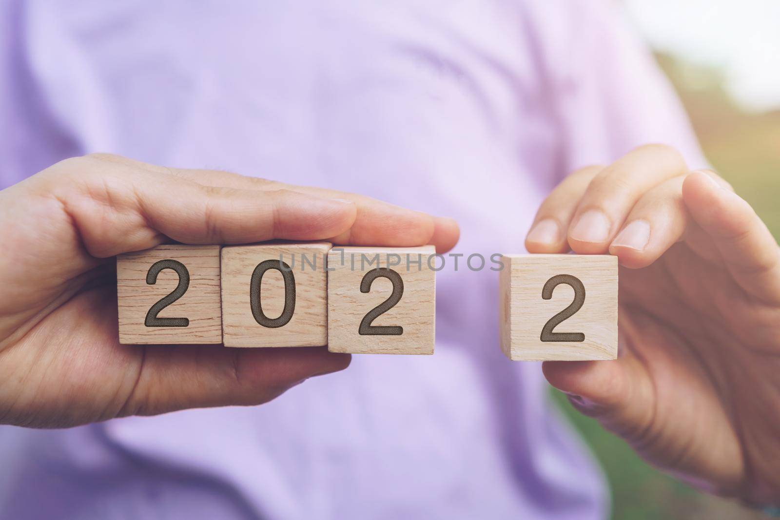 Hand hold wooden cubes 2022 background, copy space. Goal concept, action plan, strategy, new year. by Suwant