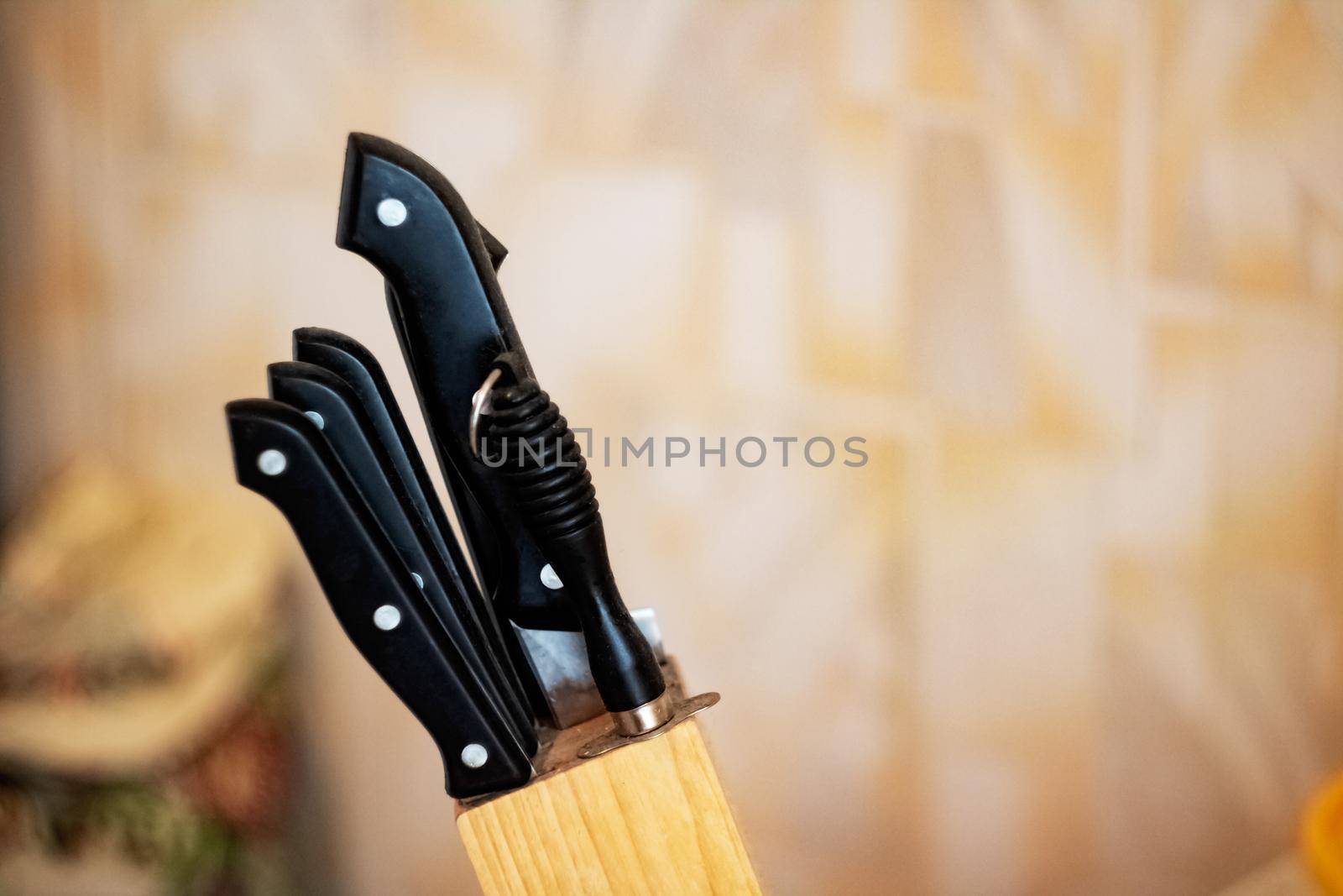 Black kitchen knives in the stand close up, copy space