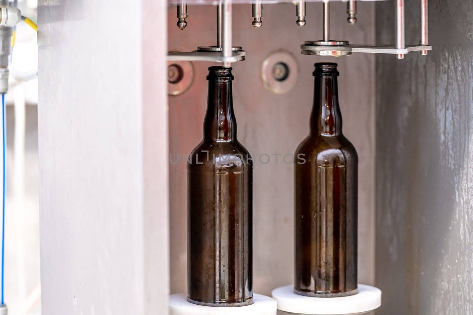 machine for washing and filling glass bottles with beer. High quality photo