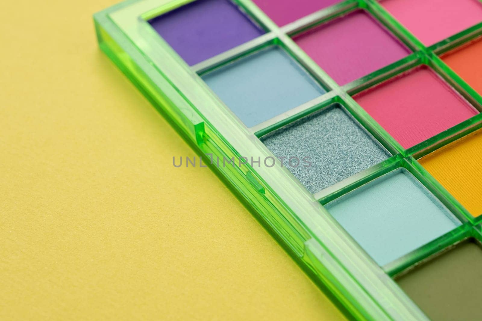 Bright eyeshadow palette closeup. Makeup cosmetics. Colorful colors. Place for text. Flat lay. Top view. layout