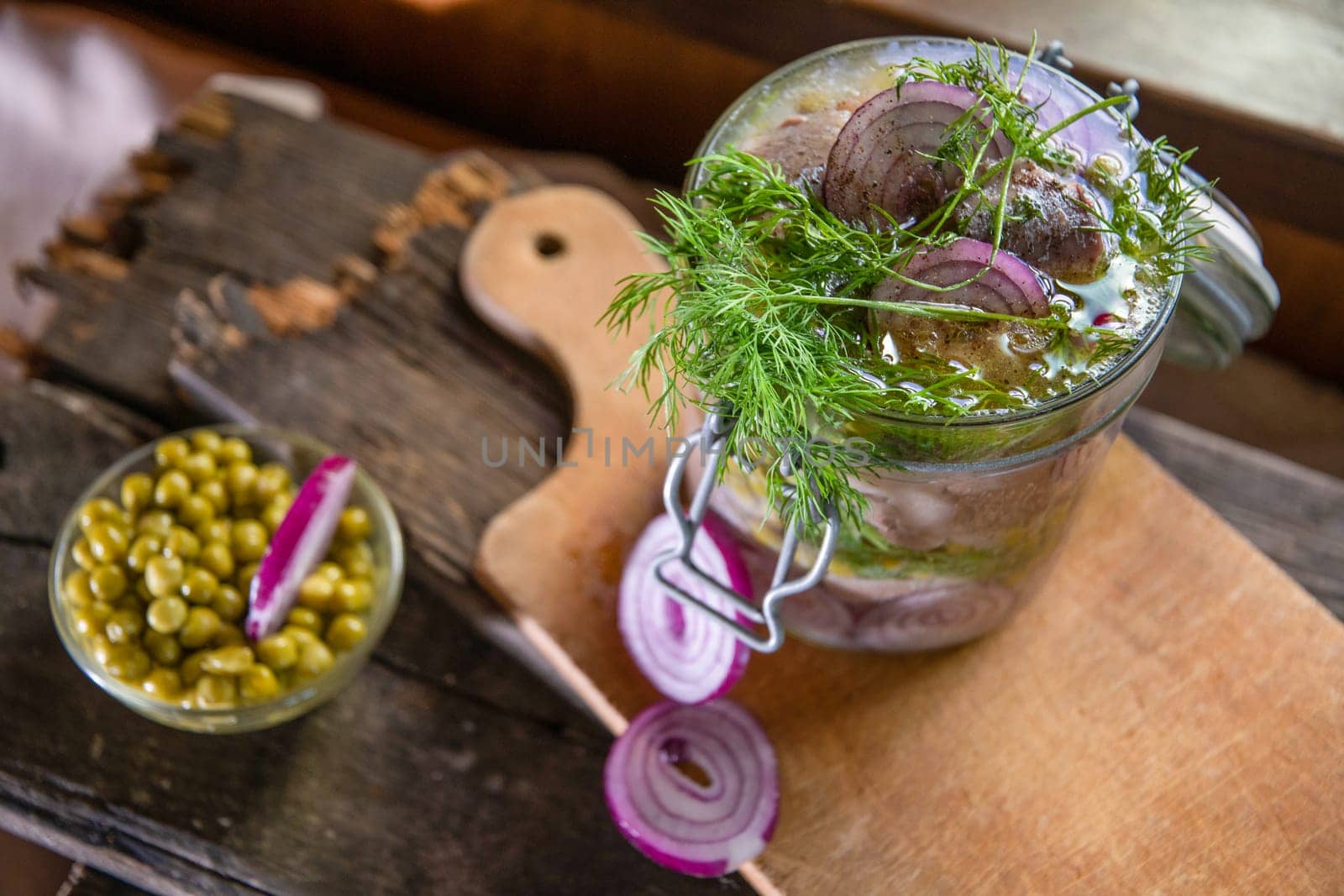 appetizer of herring with onions marinated in mustard-vinegar sauce with dill and green peas, recipe. High quality photo